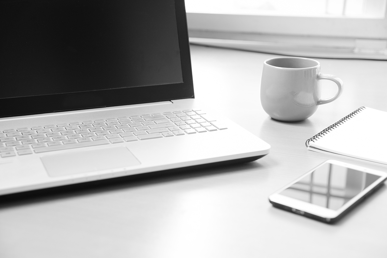smart phone notebook paper for note message and a cup of coffee on wood desk